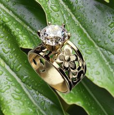 Our 15mm wide Hawaiian engraved tapered ring with 1.50 carat Cubic Zirconia is an original design we made back in 1996. The unique ring has pretty floral scroll cut-out pattern that has been handcrafted in 14K Gold-Glaze Silver. Please choose your ring size available in sizes 5, 6, 7, 8, 9, 10. This Hawaiian ring is sure to delight making a lovely gift for any occasion. Thank you for supporting local Hawaiian designers.  Enjoy free shipping to the continental USA from our Hawaii Factory. We do n Hawaiian Ring, Hawaiian Heirloom Jewelry, Hawaii Gift, Heirloom Jewelry, Hawaiian Jewelry, Heirlooms Jewelry, Island Girl, Cz Ring, Unique Ring