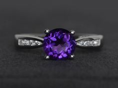 Welcome to my shop, you can find many beautiful gemstone jewelry here, and you also can ask for customized service. Main Stone: natural amethyst, round cut, measures 7X7mm, weight about 1.23 carats.Accent Stones: czMetal: 925 sterling silver plated with rhodium. I also can provide metal options such as 14k solid yellow/white/rose goldSetting: prong settingmore rings: https://www.etsy.com/shop/XCjewelryStudio?ref=hdr_shop_menuIt's a perfect gift for the person who was born in February (Birthstone Purple Amethyst Ring With Center Round Stone, Purple Amethyst Ring With Center Stone, Purple Amethyst Ring With Round Cut And Accent Stones, Round Cut Purple Amethyst Ring, Purple Amethyst Ring With Accent Stones, Elegant Purple Amethyst Ring With Round Band, Purple Amethyst Ring With Brilliant Cut, Round Brilliant Cut Amethyst Ring, Purple Brilliant Cut Amethyst Ring