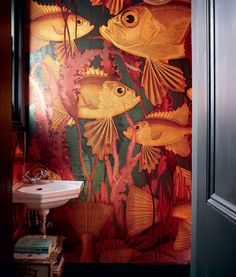 a bathroom with fish painted on the wall