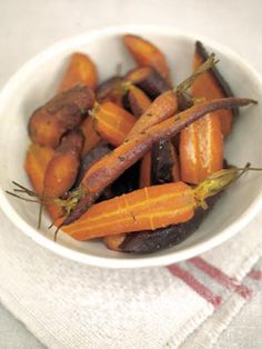 carrots and other vegetables in a white bowl