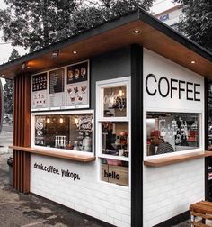 a small coffee shop sitting on the side of a road