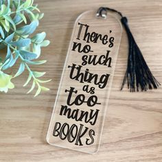 there's no such thing as too many books bookmark on a wooden table