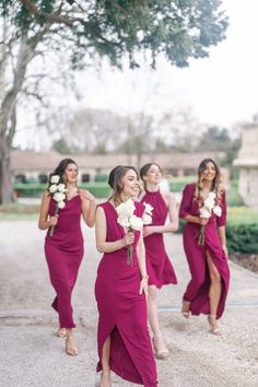 bridesmaids in red dresses walking down the street