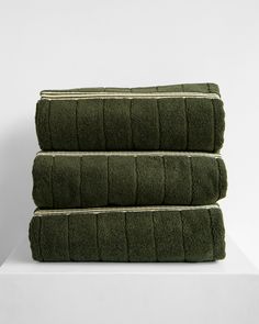 three green towels stacked on top of each other