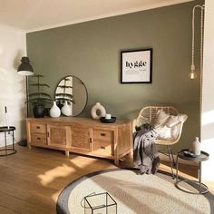 a living room filled with furniture and a mirror on top of a dresser next to a window