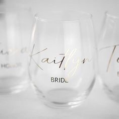 three wine glasses with gold lettering on them