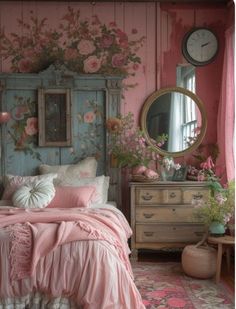 a bedroom decorated in pink and white with flowers on the wall, bedding and dresser