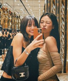 two women taking a selfie in a store