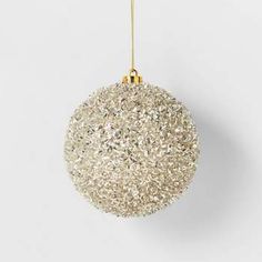 a white ornament hanging from a gold chain