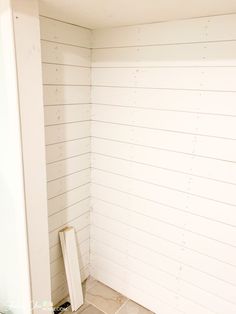 the corner of a room with white paint on the walls and tile flooring around it