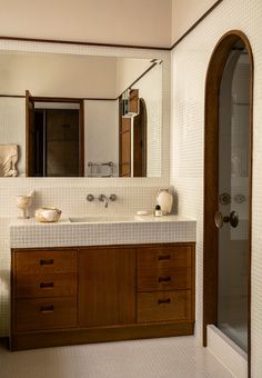 a bathroom with two sinks and a large mirror in it's center area,