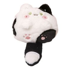 a black and white stuffed animal laying on its side