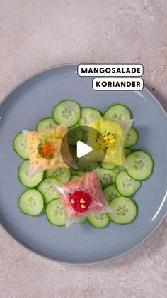 a blue plate topped with cucumbers and other food