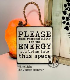 a wooden sign that says please take respitity for the energy you bring into this space