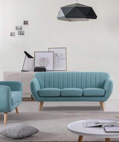 a living room with two blue couches and a coffee table in front of it