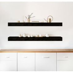 two floating shelves with cups and vases on them