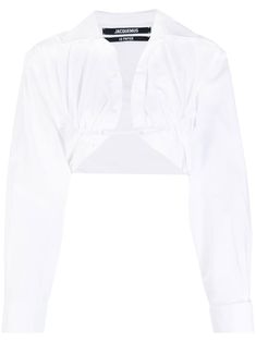 ruched-detail cropped shirt from Jacquemus featuring white, cotton, ruched detailing, cropped, curved hem, long sleeves, spread collar and strap fastening. | Jacquemus Ruched-Detail Cropped Shirt Luxury Cropped Shirt, White Long Sleeve Shirt Crop, Crop Shrug, White Button-up Cropped Shirt For Daywear, Elegant White Button-up Cropped Shirt, White Long Sleeve Cropped Shirt With Button Closure, Cropped Shirt, Shirt Long Sleeve, Airport Fashion