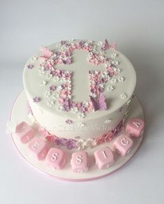 a white cake with pink and purple decorations