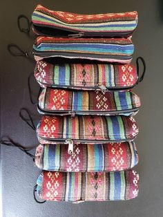 four multicolored bags are stacked on top of each other