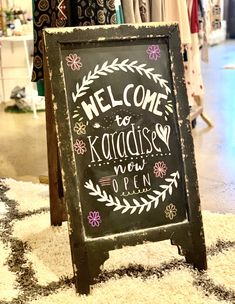 a chalkboard sign that says welcome to kansas now open