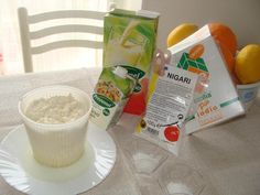 a table topped with oranges, milk and other items on top of a white plate