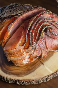 sliced ham sitting on top of a wooden cutting board