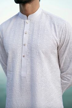 Introducing our crisp white colored men's kurta, an attire that embodies a distinctive elegance and creates a striking appearance. Our masterfully crafted white chikankari kurta features intricate details that are sure to make you stand out from the crowd. The kurta is paired with a plain trouser, creating a perfect ensemble that is both stylish and comfortable. With its impeccable craftsmanship and attention to detail, this kurta is the perfect addition to your wardrobe. Whether it's a formal occasion or a casual gathering, this white kurta is sure to turn heads and make you look your best. Invest in this exceptional look of the season and elevate your style to new heights. White Chikankari Kurta For Men, White Kurta Men, White Chikankari Kurta, Plain Kurta, Wedding Kurta, Wedding Kurta For Men, Chikankari Kurta, Kurta For Men, Men's Kurta