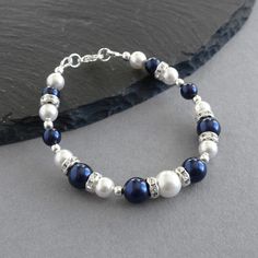 The pairing of the lustrous pearls with the sparkling crystals makes this navy pearl and crystal bracelet ideal for a wedding or special event. Created using dark blue and white glass pearls, round silver beads and crystal embellished bands, this bracelet would be ideal for bridesmaids in a navy blue themed wedding. Each single strand bracelet measures 7 inches / 17.75cm in length and is finished with a silver plated lobster clasp. I have added a 1 inch extension chain to allow you to adjust you Adjustable Blue Pearl Bracelet For Wedding, Dark Blue Bridesmaids, Navy Blue Themed Wedding, Midnight Blue Wedding, Navy Blue Jewelry, Bridal Jewels, Flower Girl Bracelets, Jewelry King, White Pearl Bracelet