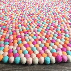 a multicolored rug with pom poms on it