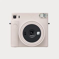 a white camera sitting on top of a rainbow colored background with the words instax