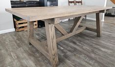 a large wooden table sitting on top of a hard wood floor