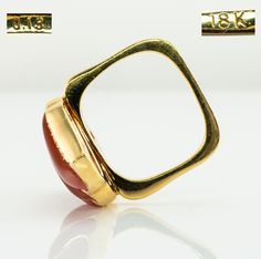 Fire Ring, Flame Ring, Orange Ring, Carnelian Ring, Diamond Ring, Vintage Ring, Gold Ring, Square Band, Gold Band, Cocktail Ring. This one of a kind estate ring is crafted in solid 18K Yellow Gold. The setting with natural Carnelian is reminiscent of flames. Absolutely stunning! Six diamonds total .13 carat of VS1 clarity and H color. The square band is 17mm x 16mm inside, it is hard to know the size. We would say the size is around 7-7.25 and the ring can easily be resized. The top of the ring Heirloom Carnelian Yellow Gold Rings, Formal Carnelian Gold Ring, Formal Gold Carnelian Ring, Gold Carnelian Ring For Anniversary, Gold Carnelian Anniversary Rings, Flame Ring, Diamond Ring Vintage, Orange Ring, Estate Ring