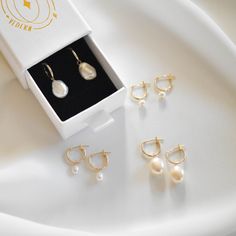 A pair of 14K gold huggie earrings 12mm in diameter with genuine freshwater pearls of your choice.  Pearl options include: - keshi pearls which features an organic, irregular shape and are 8-10 mm - mini round pearls which are 4-5mm and slightly off-round - mini oval pearls which are 3-4mm wide by 4-6mm tall. - baroque pearls have a mostly oval with slightly organic shape and smooth surface  100% 14k gold Huggies are 12mm in diameter. These earrings are made of all 14K solid gold and genuine freshwater pearl. This is a lifetime piece. Anti-tarnish, nickel-free, and waterproof.  Hoops are hollow, light-weight, and comfortable for daily wear.  --------------------♥ PROMOS ♥-------------------- Want 10% off? Join the mailing list by visiting http://bit.ly/vedern . Just leave me a note at chec Gold Huggies, Pearl Dangle Earrings, Gold Pearl Earrings, Pearl Hoop Earrings, Keshi Pearls, Pearl Earrings Dangle, Huggie Earrings, Mailing List, Gold Hoops