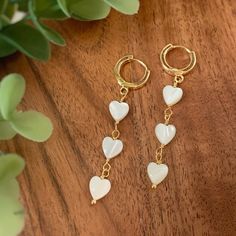 🤎 Item details 🤎 Size: Hoop 12x2mm    Total length 5cm Material: White Mother of Pearl High quality 18k gold plated hoop earrings Trendy Gold Heart Earrings With Heart Beads, Trendy Gold Heart Earrings With Beads, White Dainty Heart Earrings For Pierced Ears, White Dainty Earrings With Heart Charm, Dainty White Heart Earrings For Pierced Ears, White Gold Plated Single Hoop Earring, White Dangle Heart Earrings With Ear Wire, Trendy Dangle Heart Beads Jewelry, White Dainty Gold-plated Hoop Earrings