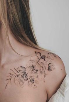 the back of a woman's shoulder with flowers on it