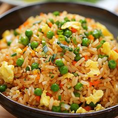 a bowl filled with rice and peas on top of a table