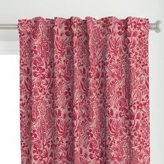 a red and white curtain hanging on the side of a window