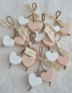 small heart shaped soaps tied with twine on a white lace tablecloth for decoration