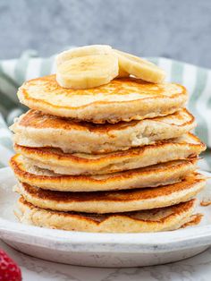 a stack of pancakes with bananas on top