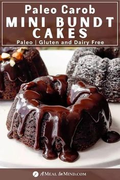 a close up of a bundt cake on a plate with chocolate icing and nuts