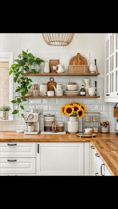 a kitchen with sunflowers on the counter and shelves filled with pots and pans