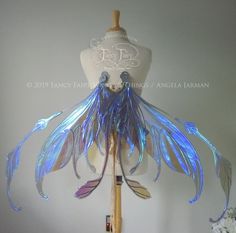 a mannequin with blue feathers on it