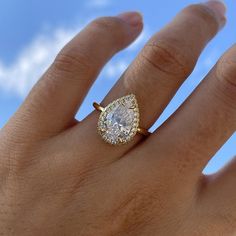 a woman's hand with a ring on it and a diamond in the middle