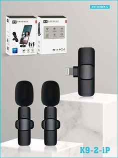 two black speakers are sitting next to each other in front of a box with the same product on it