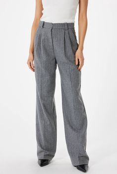 The pin stripe high-waisted women's trouser pant is an elegant and sophisticated piece of attire that seamlessly blends classic style with a modern flair. Crafted with meticulous attention to detail, these trousers offer a flattering silhouette that accentuates the waist while providing a comfortable and confident fit.Designed to sit gracefully at the natural waist, the high-waisted cut adds a vintage-inspired element to the trousers. It not only offers a retro appeal but also contributes to an Luxury Vertical Striped Pants For Business Casual, Luxury Pinstripe Wide Leg Pants For Formal Occasions, Luxury Tailored Striped Dress Pants, Luxury Striped Dress Pants For Business, Cheap High-waist Pinstripe Pants, Cheap High Waist Pinstripe Pants, Luxury Pinstripe Dress Pants For Work, Luxury Pinstripe Dress Pants For Formal Occasions, Luxury Pinstripe Bottoms For Formal Occasions