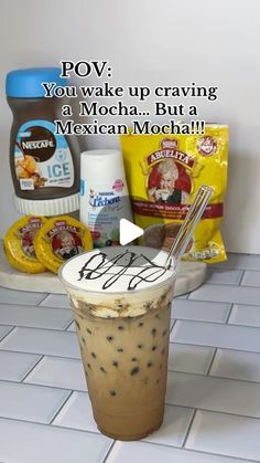 an iced drink with ice cream and chocolate chips on the side, next to some condiments