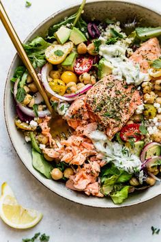 salmon and chickpea salad in a bowl with two chopsticks on the side