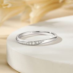 Simply and chic, this band is a clever accessory you will love. Featuring white stones, this band is an elegant symbol of your marital commitment. Buffed to a brilliant luster, this comfort-fit wedding band  will make your vows shine.Carat Weight: 0.086 ctStone Size: 1.1,1.3,1.5 mmStone Type: Jeulia® StoneNumber of Stones: 5 Stone Color: Diamond WhiteStone Shape: RoundWeight: 1.6 gWidth: 1.8 mmHeight: 1.8 mmThickness: 1.1 mmMaterial: 925 SilverPlating Color: Silver Minimalist Half Eternity Band For Formal Occasions, Minimalist Formal Half Eternity Band, Elegant Stackable Eternity Band, Minimalist Diamond Bands For Anniversary, Minimalist Diamond Anniversary Bands, Elegant White Bands For Anniversary, Elegant White Band For Anniversary, Elegant Sterling Silver Half Eternity Ring, Elegant Stackable Diamond Ring