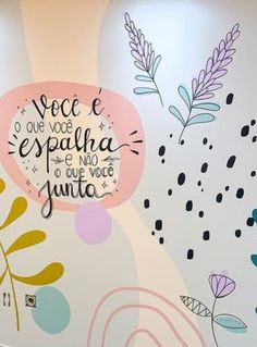 the wall is painted with colorful flowers and words on it, as well as lettering that says