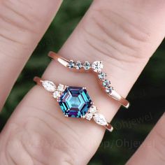 two rings with blue and white stones on each one, set in 18k rose gold